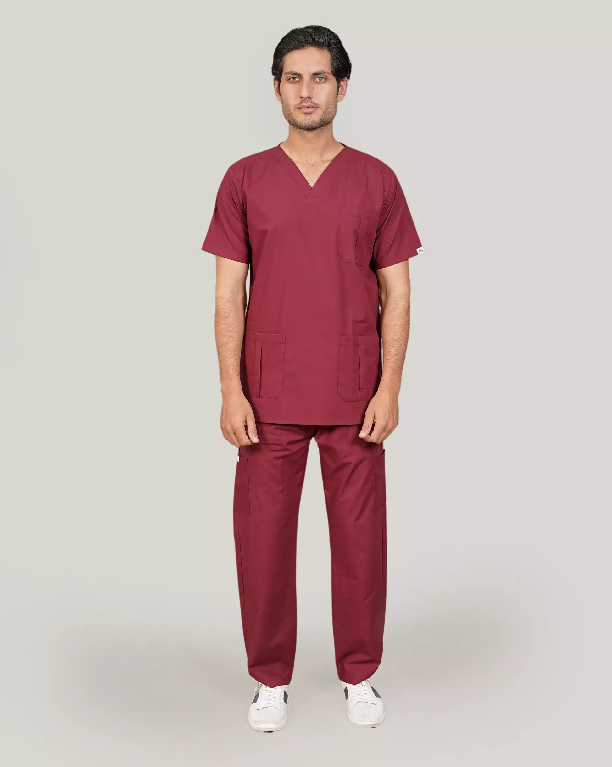 Full-body image of a male medical professional in a complete charcoal grey Medfit men's scrub set with a stethoscope, ideal for a modern and functional medical uniform.