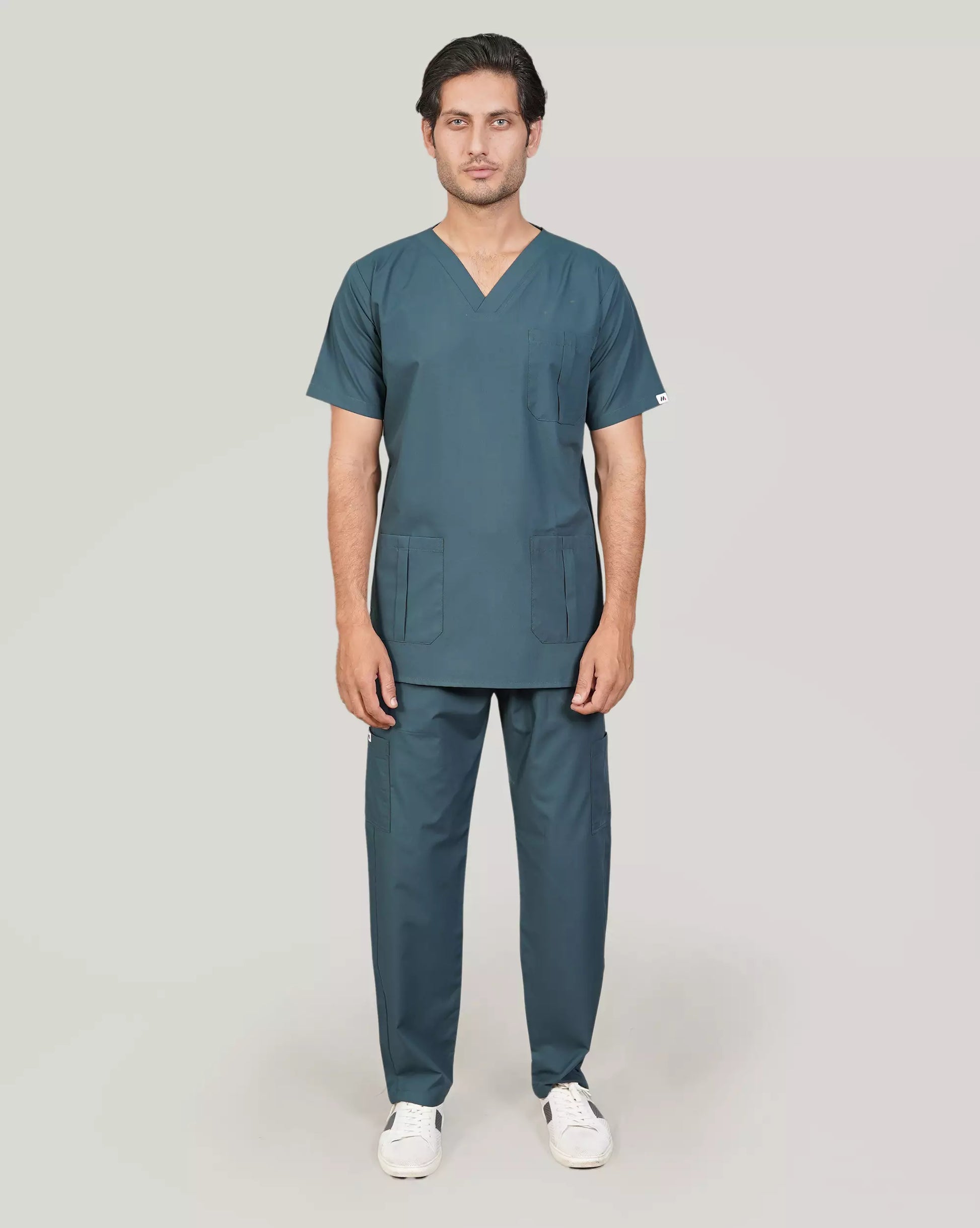 Full-body front view of a male medical professional in an emerald green Medfit men's scrub set, ideal for a comfortable and professional medical uniform.