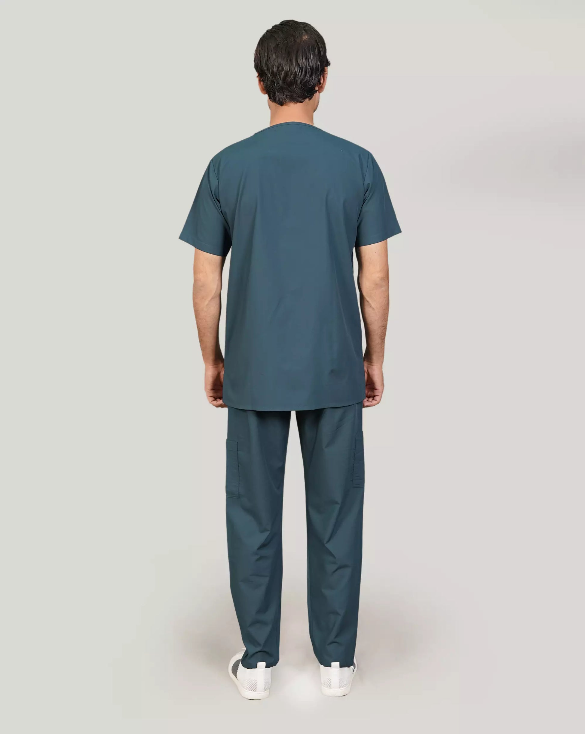 Rear view of a male medical professional in an emerald green Medfit men's scrub set, showcasing the comfortable fit and professional appearance for healthcare.