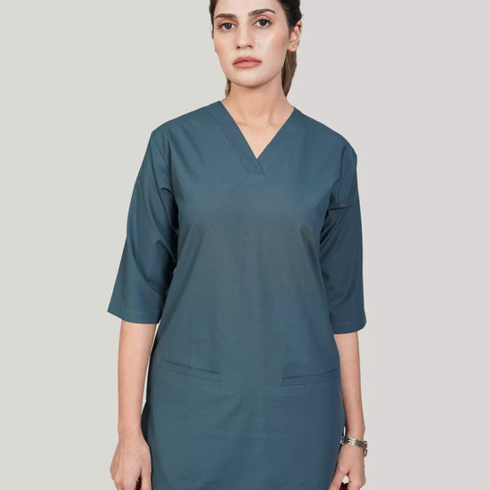lady doctor wearing a teal scrub set on a plain background