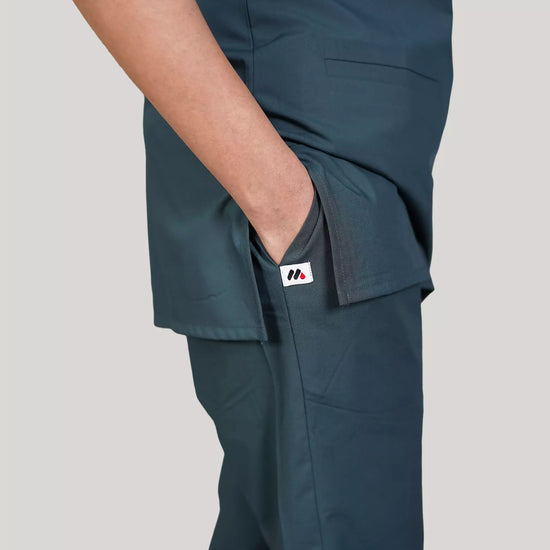 Navy blue medical scrubs with pockets on a plain background