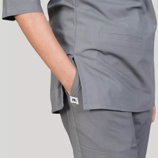 Gray scrub set worn by a women on a plain background