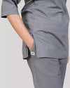 Gray scrub set worn by a women on a plain background