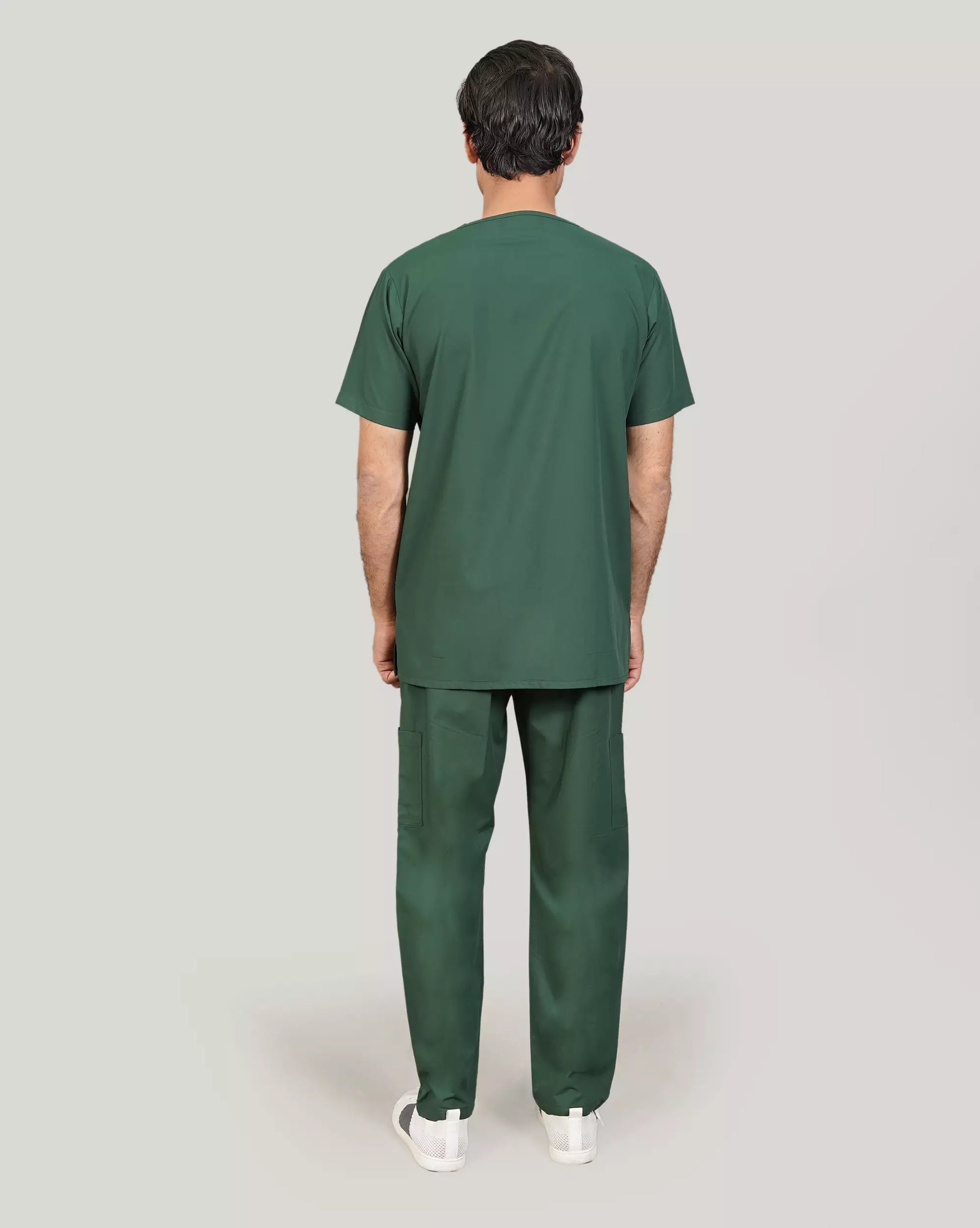 Rear view of a male medical professional wearing a hunter green Medfit scrub set, showcasing the full design and comfortable fit for healthcare workers.