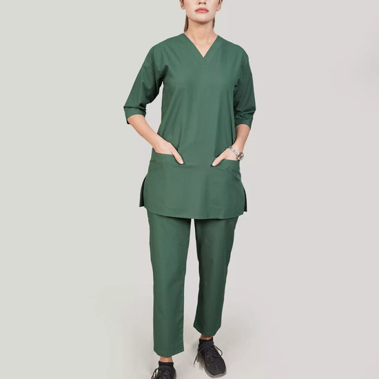 Person wearing a green medical scrub set on a plain background