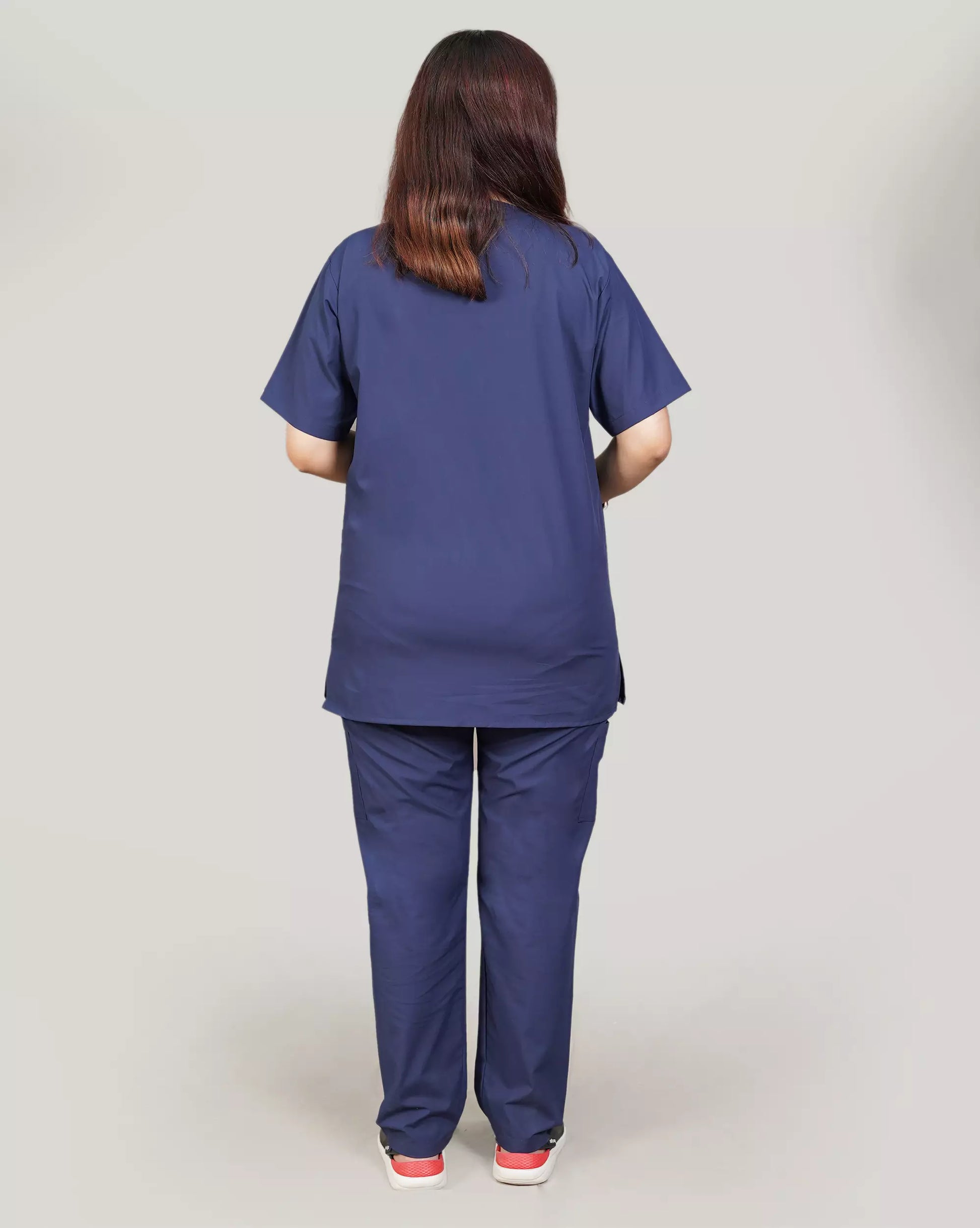 Rear view of a female medical professional in a navy blue Medfit unisex scrub set, highlighting the comfortable fit and professional appearance for healthcare.