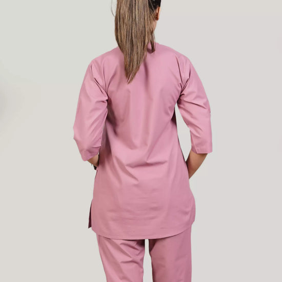 Person wearing a pink scrub set from the back.