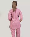 Person wearing a pink scrub set from the back.