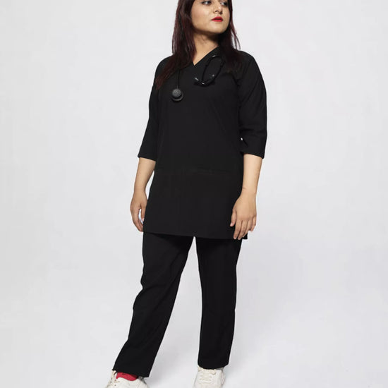 female wearing a black scrub outfit on a white background