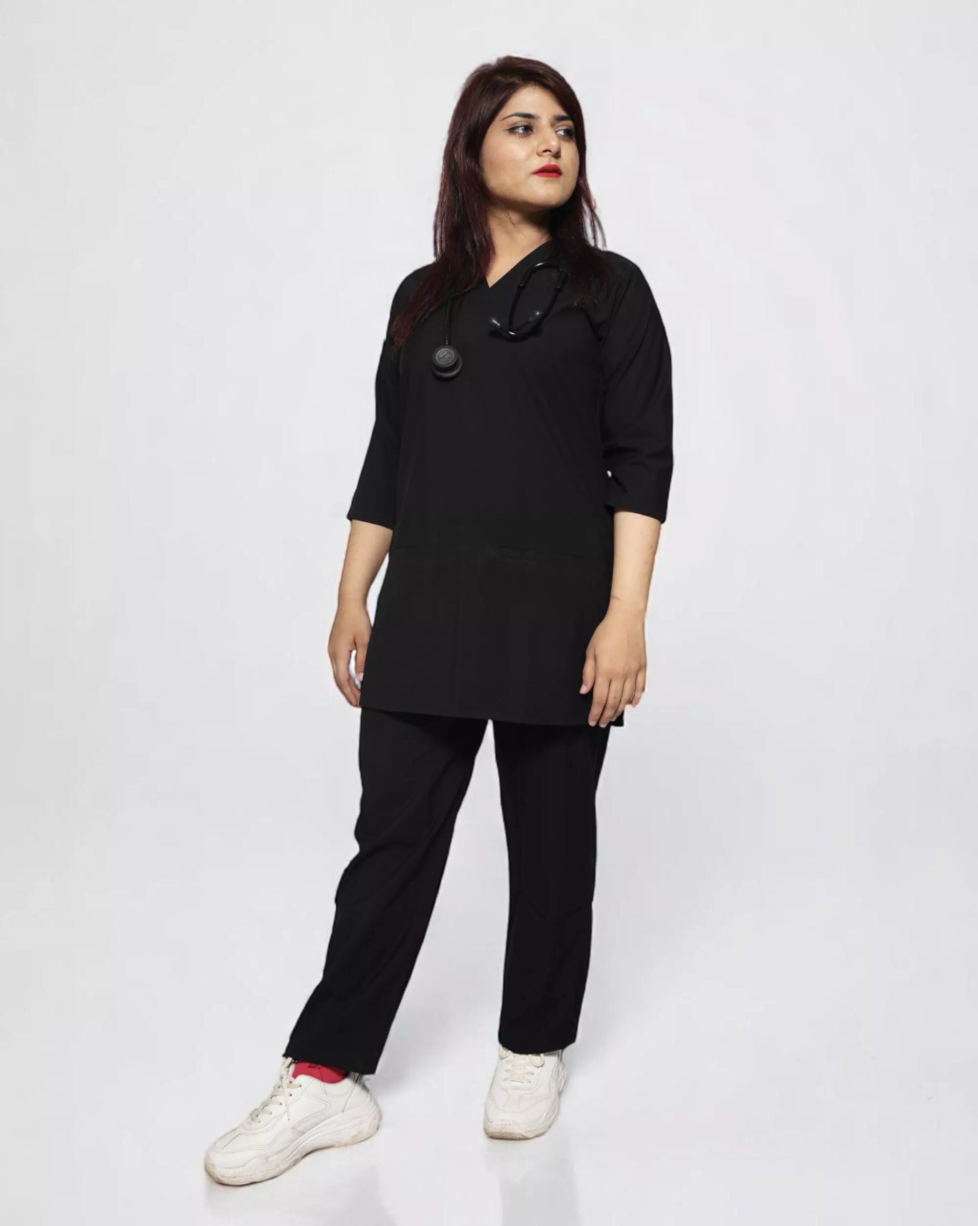 female wearing a black scrub outfit on a white background