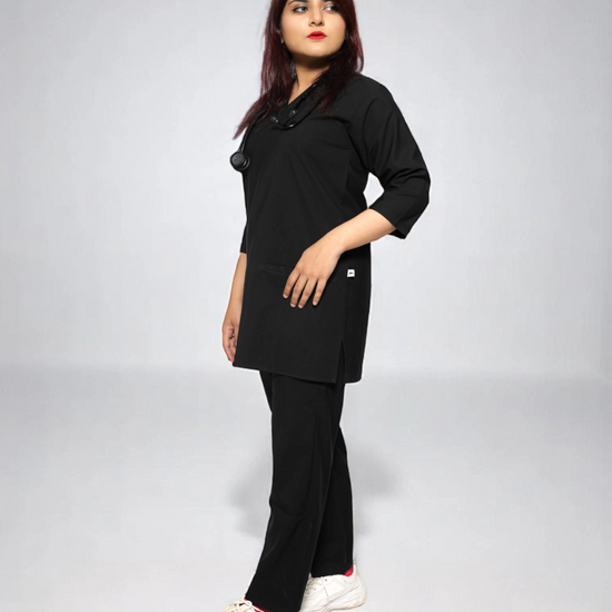 Person wearing a black outfit on a plain background