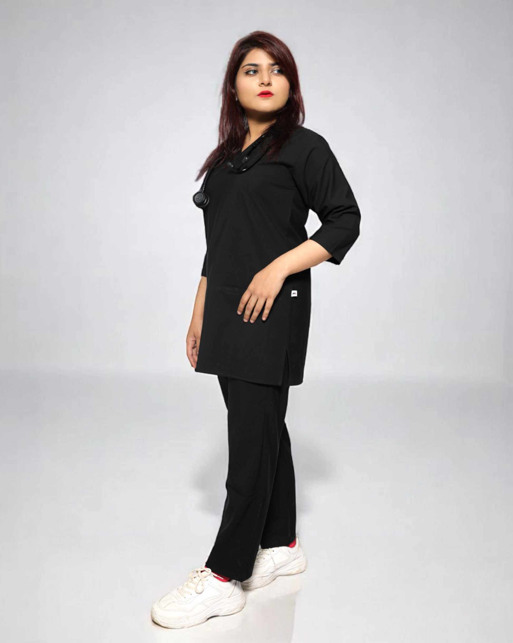 Person wearing a black outfit on a plain background