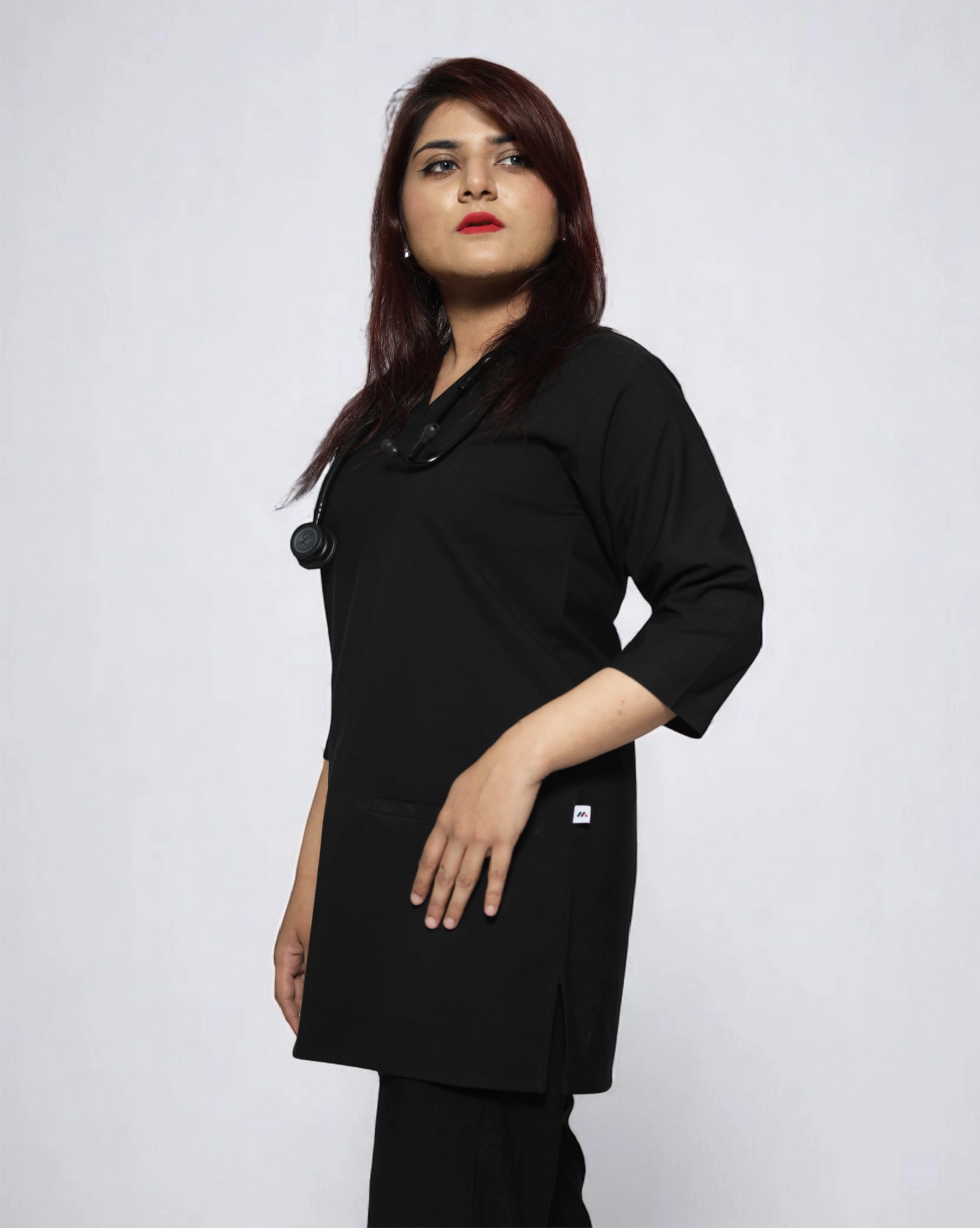 Person wearing a black coat against a white background
