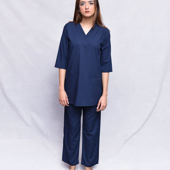 Woman wearing a navy blue outfit against a white background