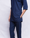Navy blue scrub set on a white background