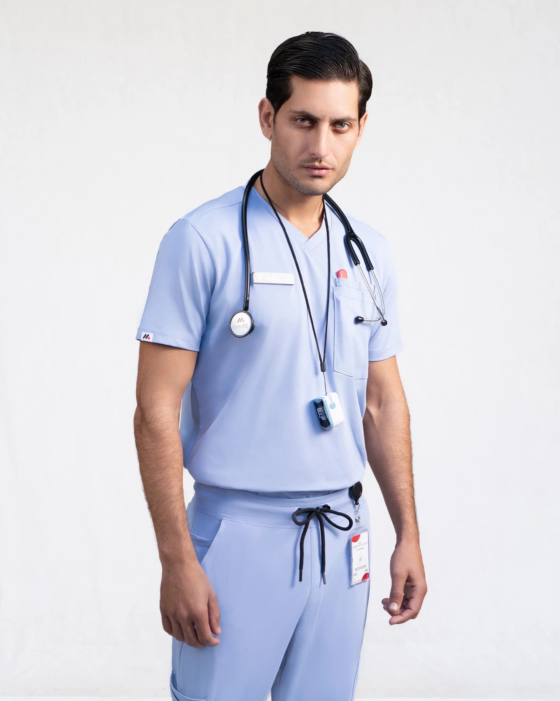 Person wearing light blue medical scrubs with a stethoscope.