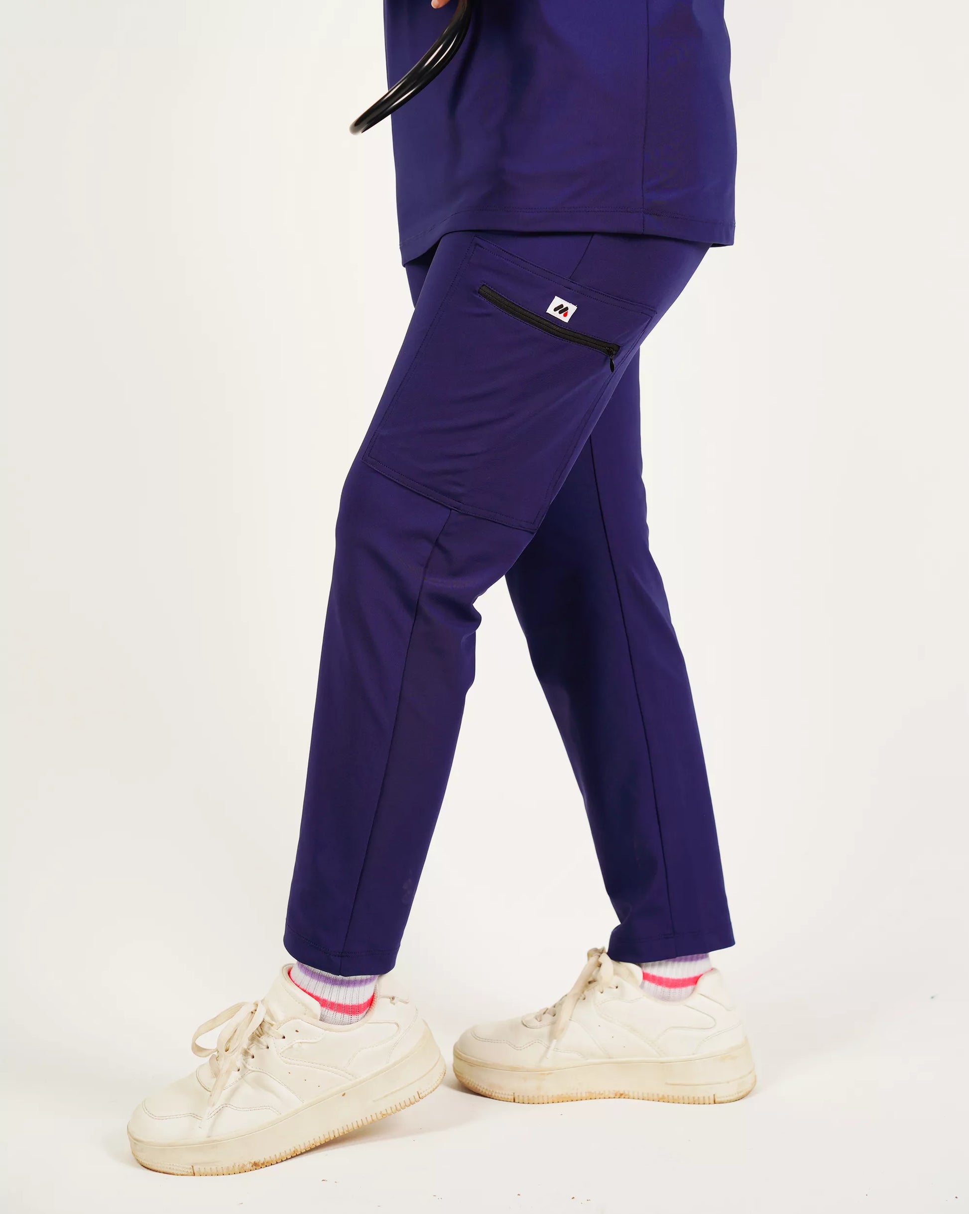 Navy blue pants worn by a person on a white background