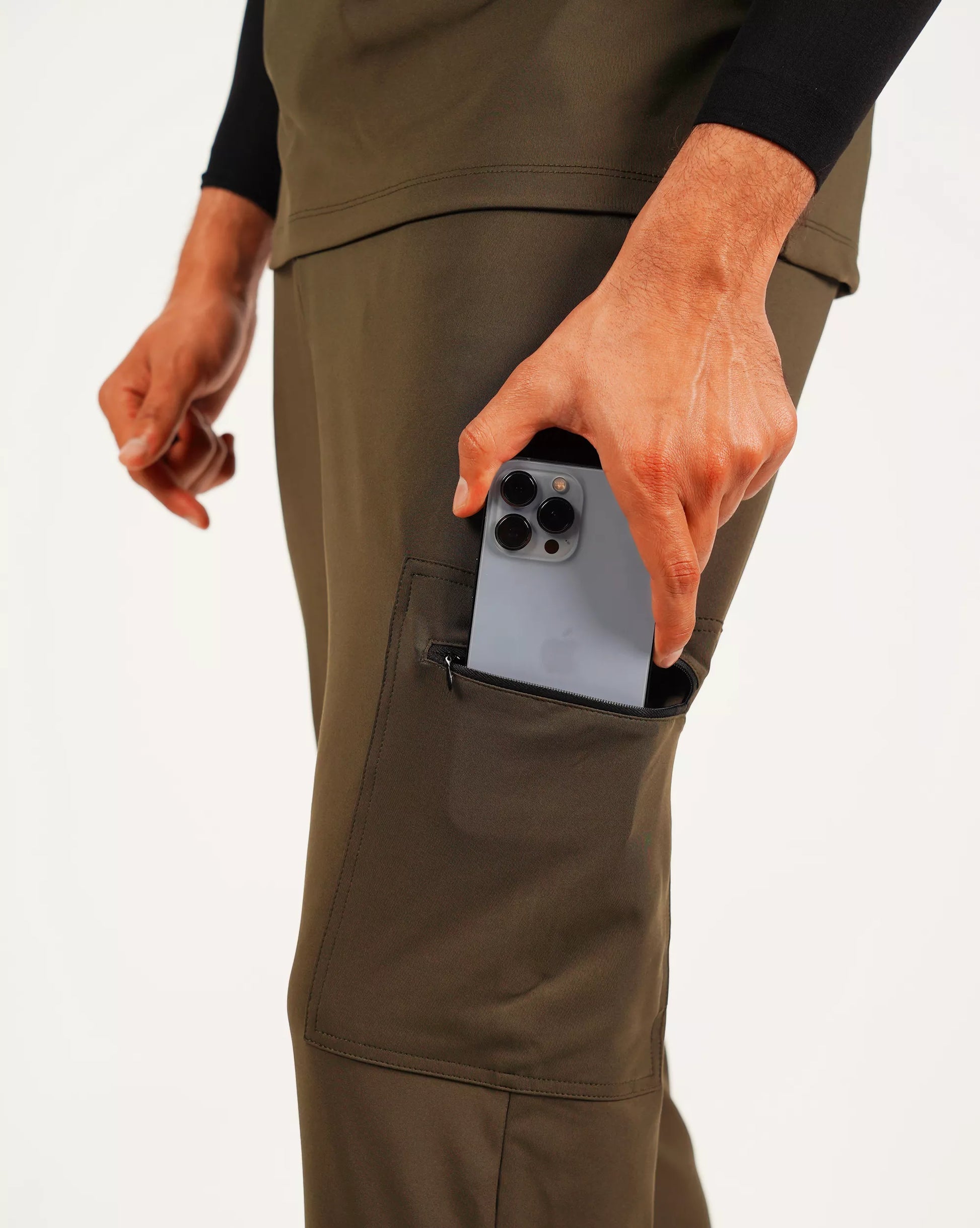 Person using a pocket on their pants to hold a phone.