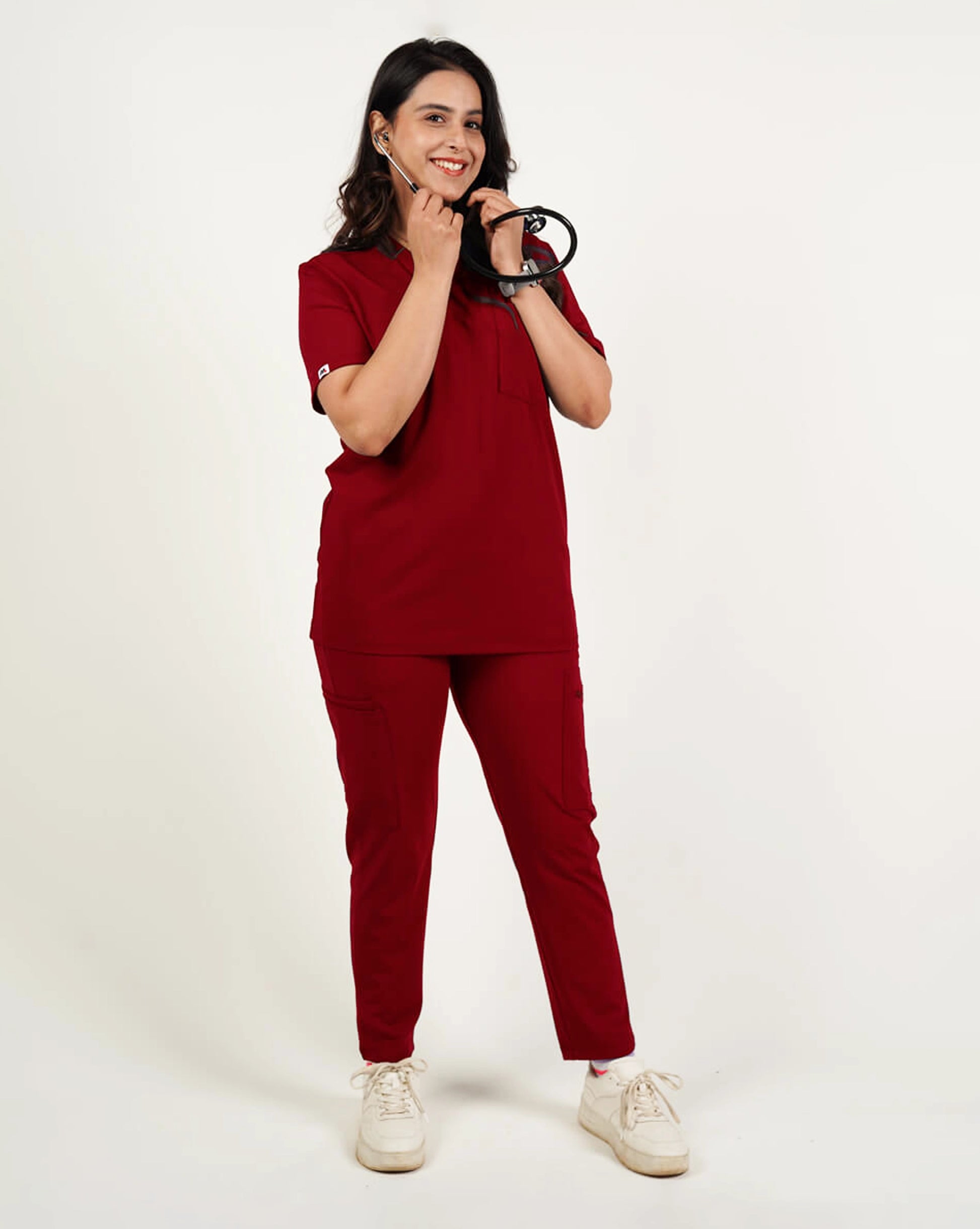 Woman wearing a red outfit with white sneakers on a white background