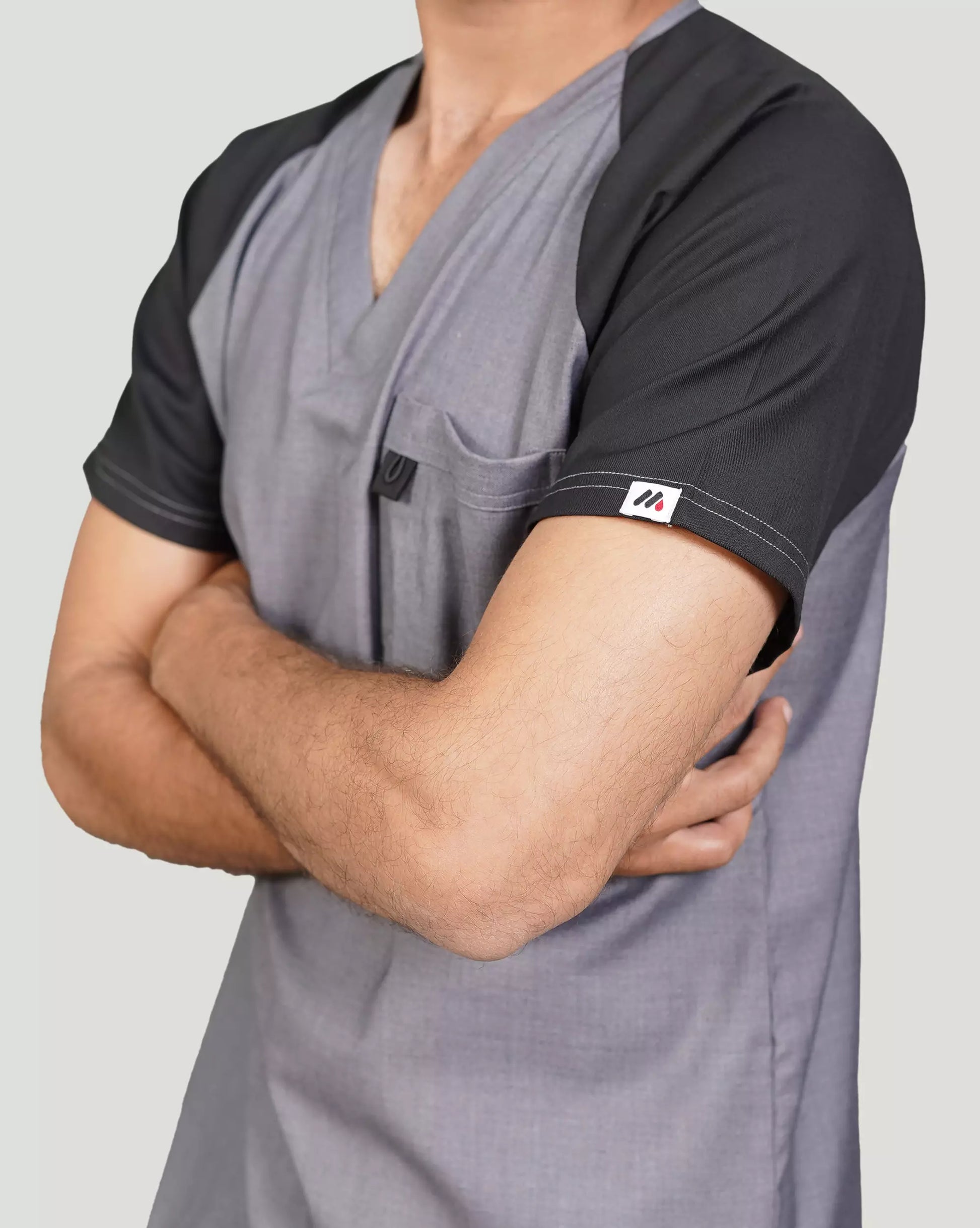 Gray and black scrub top worn by a doctor.