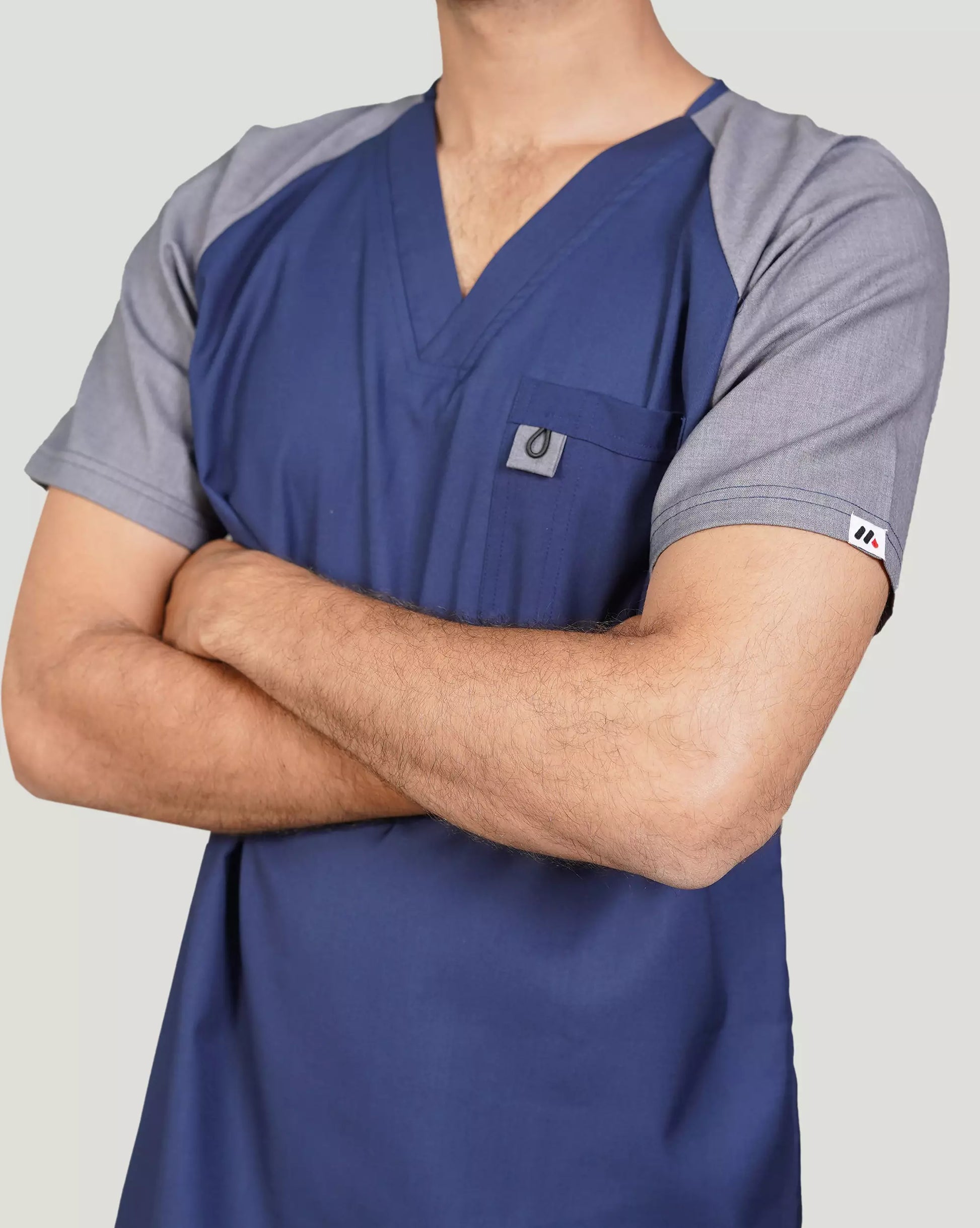 Blue and gray scrub top worn by a person.