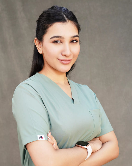 Close-up of a confident female medical professional in a stylish sage green Medfit scrub, highlighting quality and modern design for healthcare.