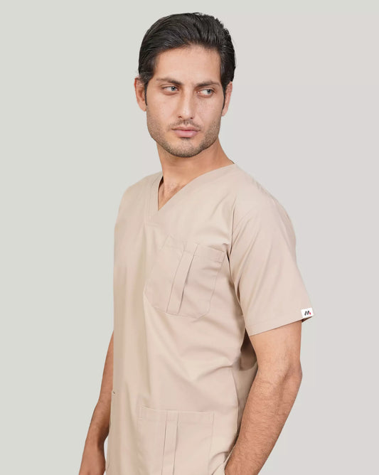 Side profile of a male medical professional in a beige Medfit men's scrub top, highlighting the comfortable V-neck and practical design for healthcare settings.