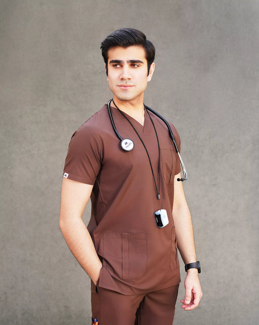 Full-body profile of a female medical professional in a sleek black Medfit unisex scrub set, featuring practical pockets and the Medfit logo on the leg for professional wear