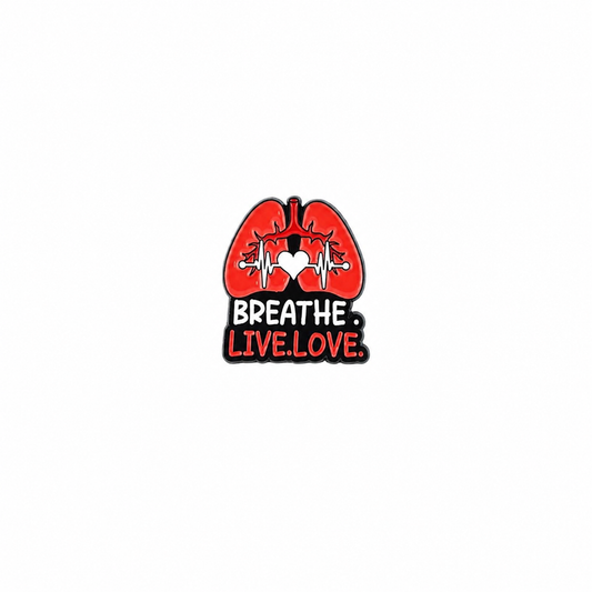An enamel lapel pin featuring a red anatomical lungs graphic with a heart and EKG line motif, accompanied by the text "BREATHE. LIVE. LOVE." against a white background.
