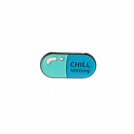 A blue and green pill-shaped enamel pin featuring the text 'CHILL 1000mg', perfect as a quirky medical-themed accessory, displayed on a white background.