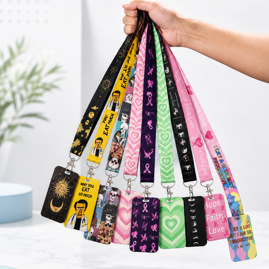 A hand holding a diverse collection of colorful printed neck lanyards and matching ID badge card holders by MedFit.