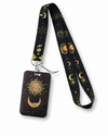 Mystical black neck lanyard and matching ID badge holder with a gold celestial sun, moon, and stars pattern by MedFit.