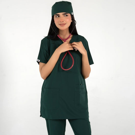 A healthcare professional wearing a dark green medical scrub set, matching scrub cap, and a red-tubed stethoscope around her neck against a white background.