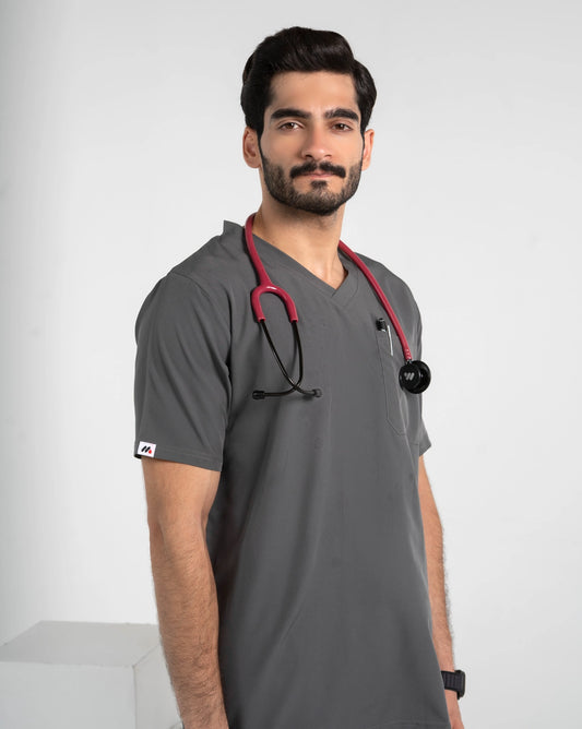 Close-up of a male model wearing a dark gray V-neck medical scrub top with a red stethoscope, MedFit professional healthcare apparel.