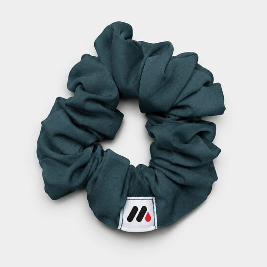 MedFit emerald green fabric hair scrunchie with logo tag for nurses and healthcare workers.