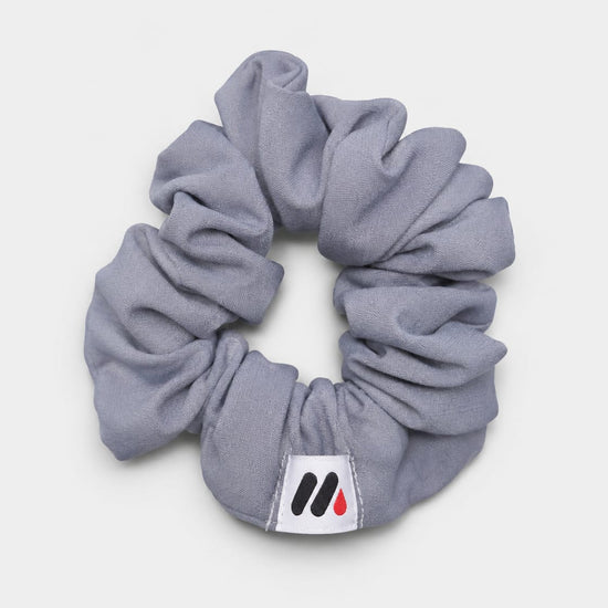 MedFit graphite grey fabric hair scrunchie with logo tag for nurses and healthcare workers.