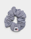 MedFit graphite grey fabric hair scrunchie with logo tag for nurses and healthcare workers.