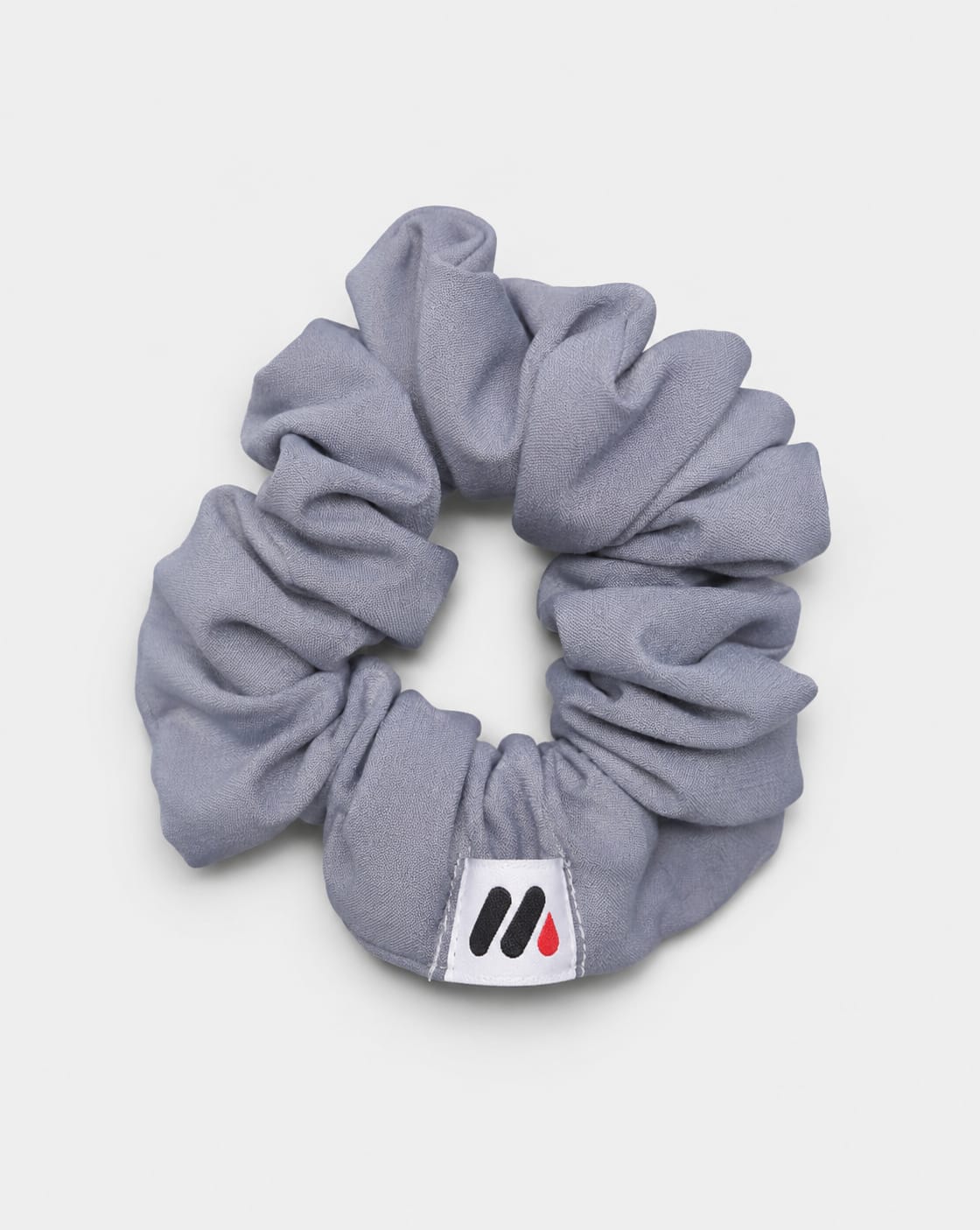 MedFit graphite grey fabric hair scrunchie with logo tag for nurses and healthcare workers.