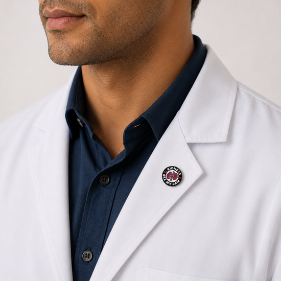 A healthcare professional wearing a crisp white lab coat styled with a unique circular logo enamel pin on the lapel.