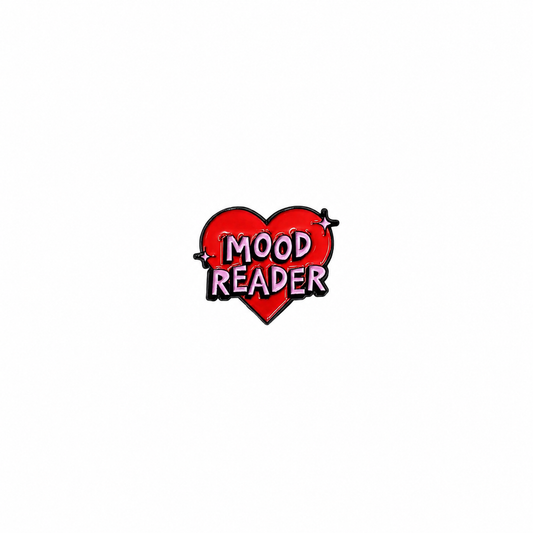 A red heart-shaped enamel lapel pin featuring the text "MOOD READER" in bold pink lettering against a white background.