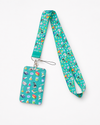 Teal neck lanyard and matching ID card holder featuring a colorful laboratory science gear pattern with microscopes and beakers, by MedFit.