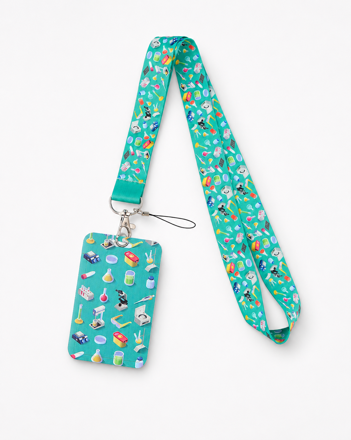 Teal neck lanyard and matching ID card holder featuring a colorful laboratory science gear pattern with microscopes and beakers, by MedFit.