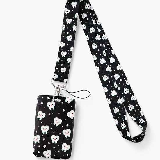 Cute black dental lanyard with a smiling teeth and stars pattern, featuring a matching ID badge holder by MedFit.
