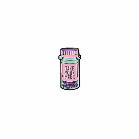 A cute, illustrated pill bottle enamel pin featuring the text 'TAKE YOUR + MEDS', a perfect medical-themed accessory, displayed on a white background.