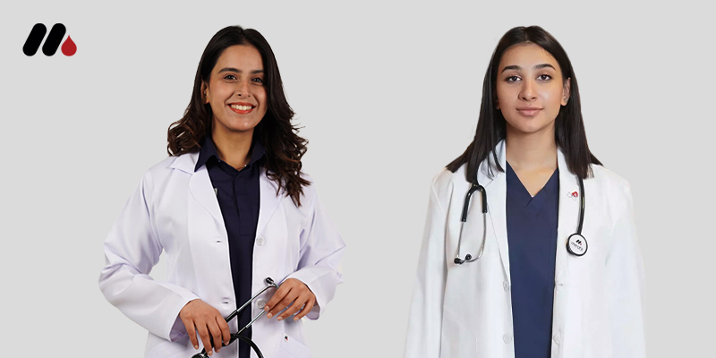 Two women, likely medical professionals, wearing white lab coats and stethoscopes, smile against a white background.